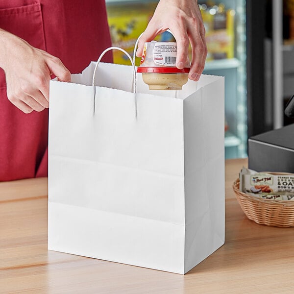 a person putting a jar into a bag