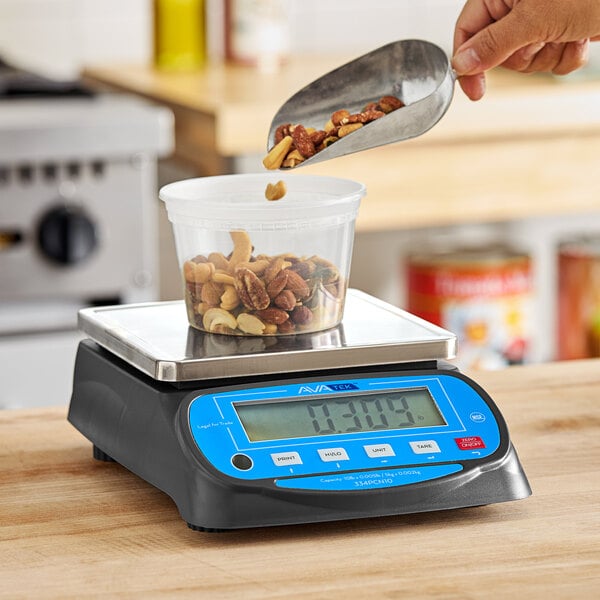 A person using an AvaWeigh portion scale to pour nuts into a container.