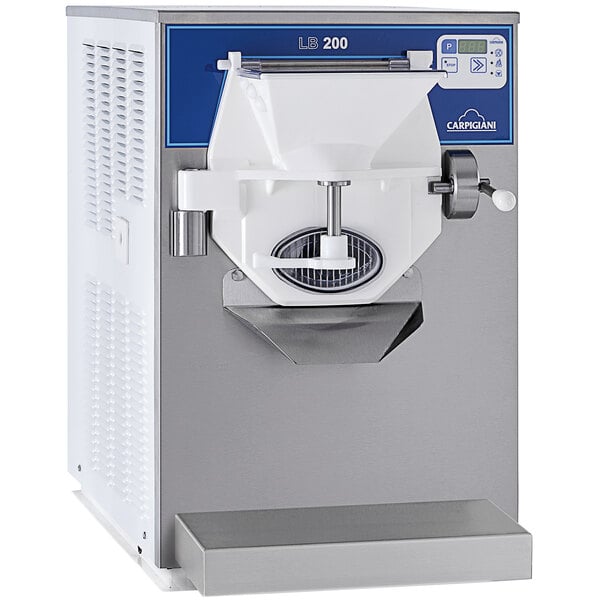 A Carpigiani commercial ice cream batch freezer with a blue and white cover.