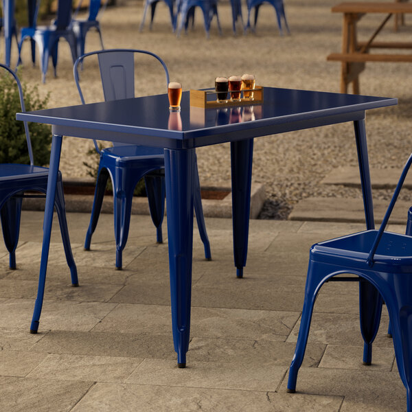 A blue table and chair on a patio.