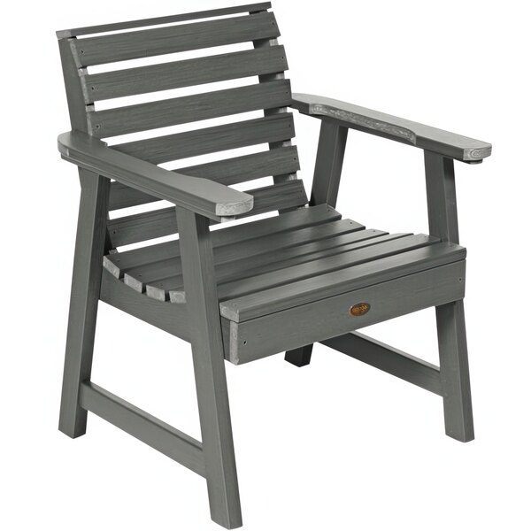 A Sequoia Coastal Teak faux wood outdoor arm chair with grey slats and armrests.