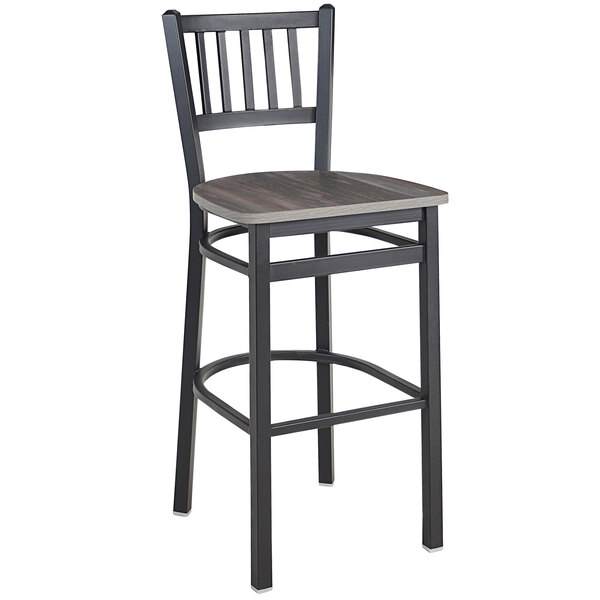 A BFM Seating black steel slat back barstool with a wood seat.