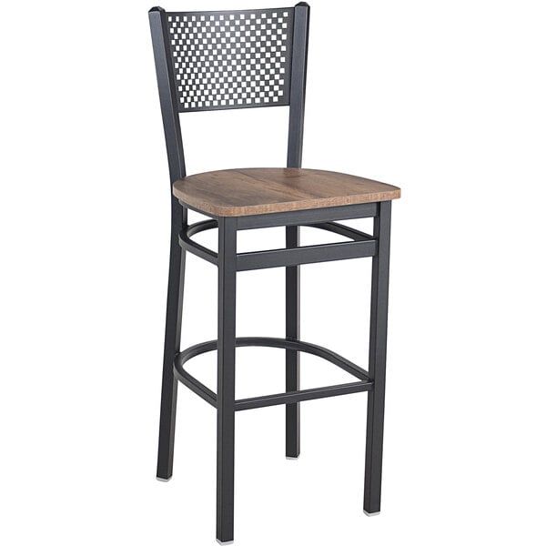 A BFM Seating black steel barstool with a wooden seat.