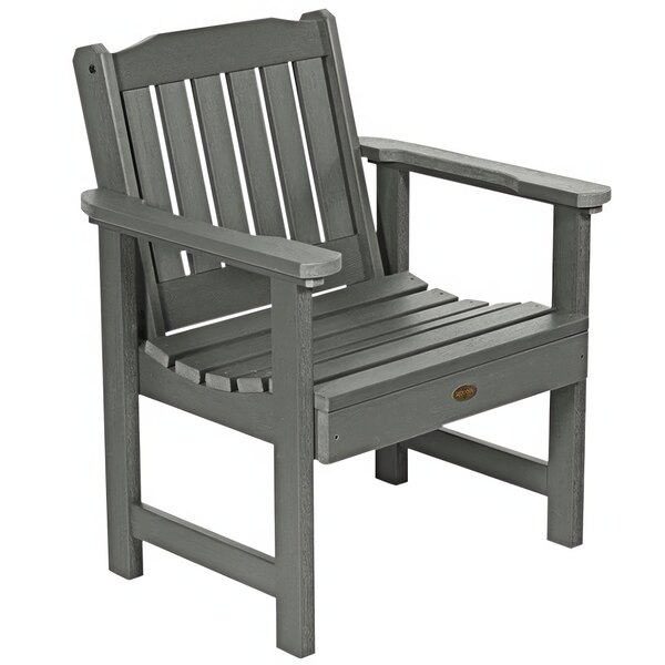 A Coastal Teak faux wood outdoor arm chair with gray armrests.