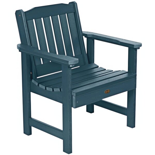 A Nantucket blue faux wood outdoor arm chair with a wooden arm.