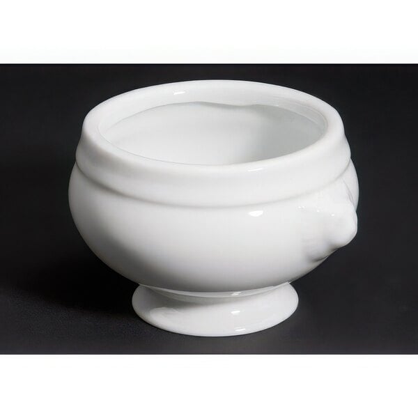 A bright white porcelain lion head bouillon bowl.
