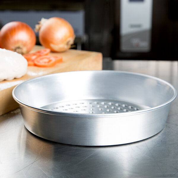 An American Metalcraft silver aluminum pan with holes.