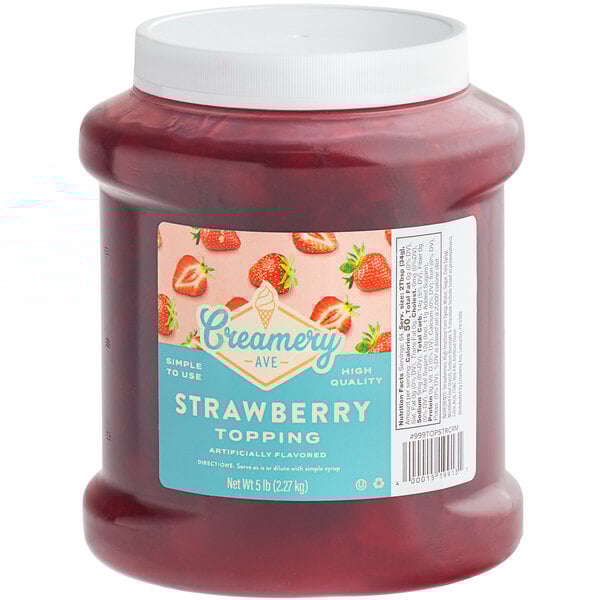 A jar of Creamery Ave. Strawberry Dessert topping on a counter.