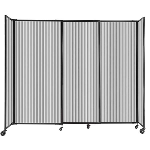 A clear poly StraightWall sliding room divider with black metal accents on wheels.