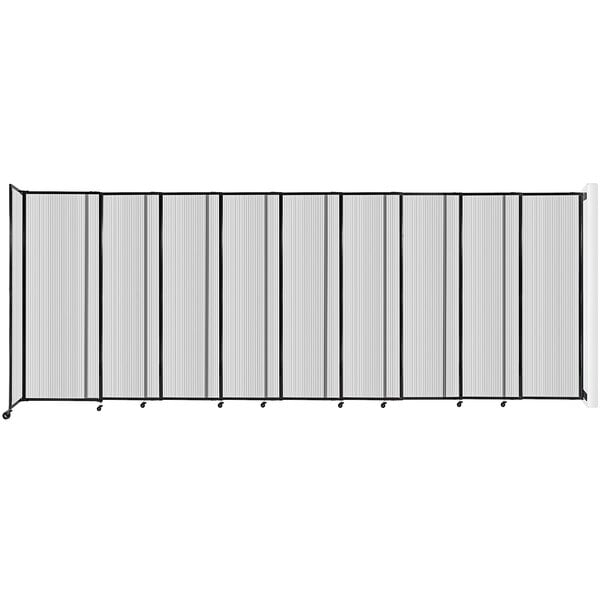 A clear poly Versare wall-mounted room divider with black and white vertical lines.