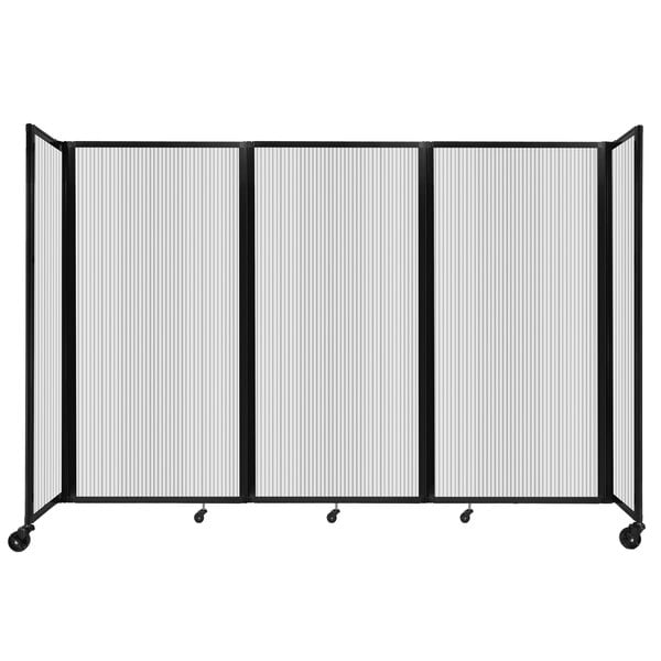 A clear polycarbonate room divider with wheels.