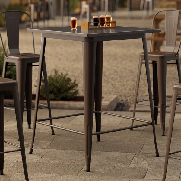 A Lancaster Table & Seating copper bar table on an outdoor patio.