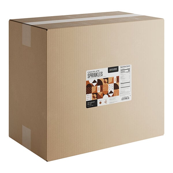 A large cardboard box labeled as containing 50 pounds of Adourne chocolate sprinkles.