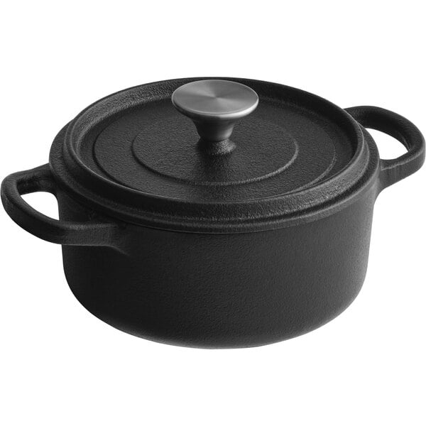 A black Valor pre-seasoned cast iron Dutch oven with a lid.