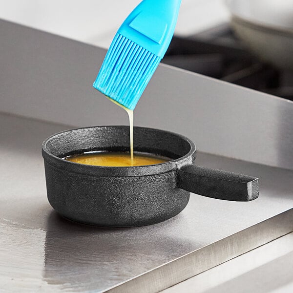 a blue brush over a saucepan