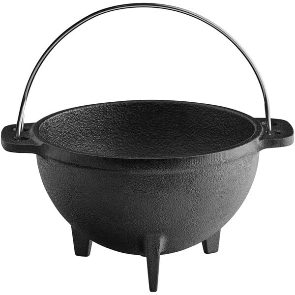 A black cast iron bowl with a handle.