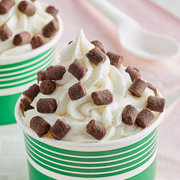 A cup of ice cream with 10 lb. Fudge Brownie Center squares on top.