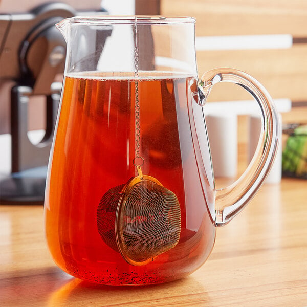 tea ball infuser with chain in a pitcher of tea