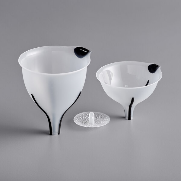 A couple of plastic funnels on a white surface.