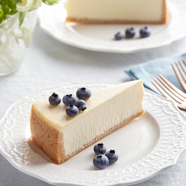 A slice of David's Cookies New York cheesecake with blueberries on a plate.