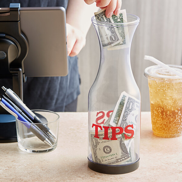 staff placing tip in a tip jar