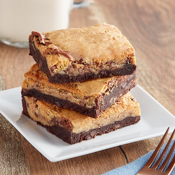 A plate with three David's Cookies brookie brownie cookie bars on it.