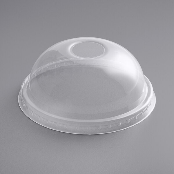 A clear plastic dome lid with an opening over a clear plastic cup.