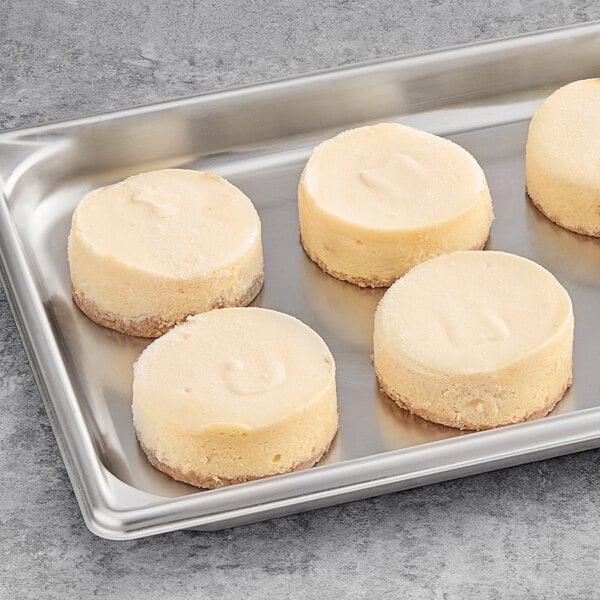 A tray of David's Cookies Mini New York Cheesecakes on a gray surface.