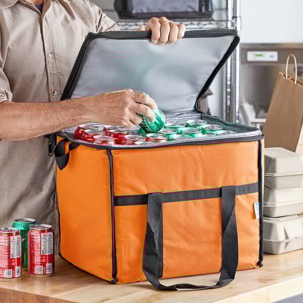 a hand holding a green can