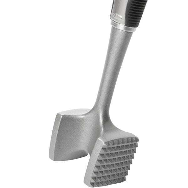 An OXO silver aluminum meat tenderizer with two handles.