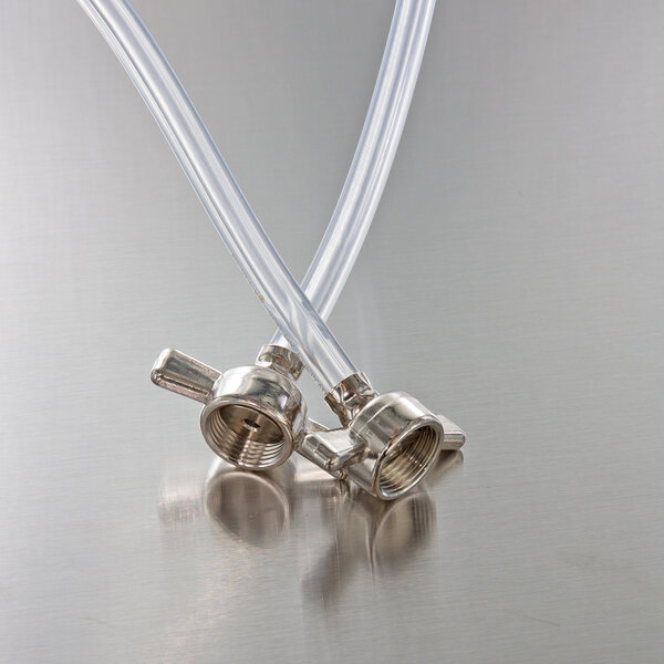 Two clear plastic hoses with metal nozzles.