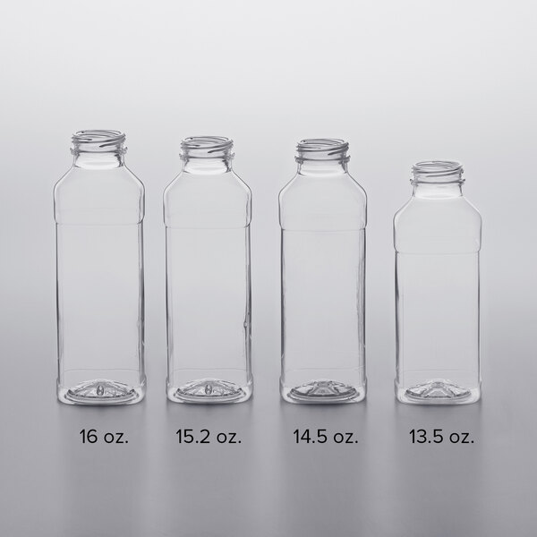 A row of clear square PET juice bottles with white lids.