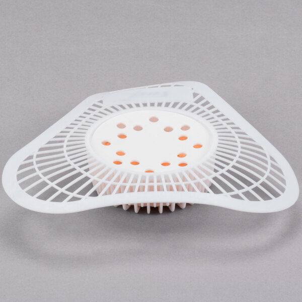 A white plastic Lavex urinal screen with holes.