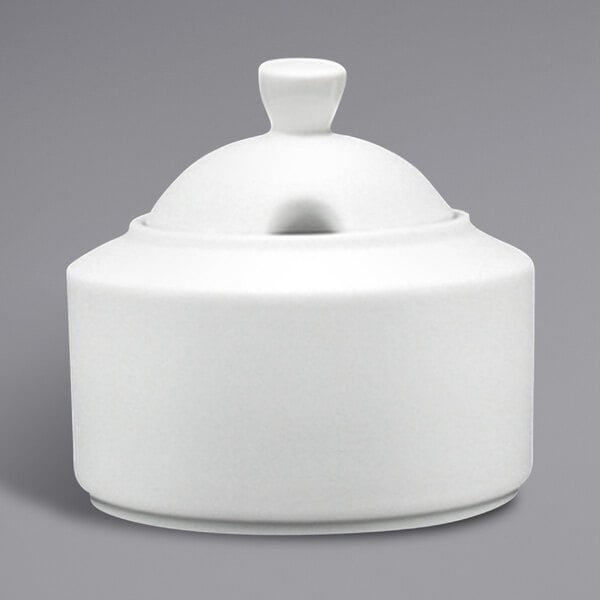 A Fortessa Ilona white ceramic sugar bowl with a lid.