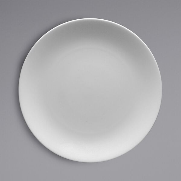 A white Fortessa Caldera china plate on a grey background.