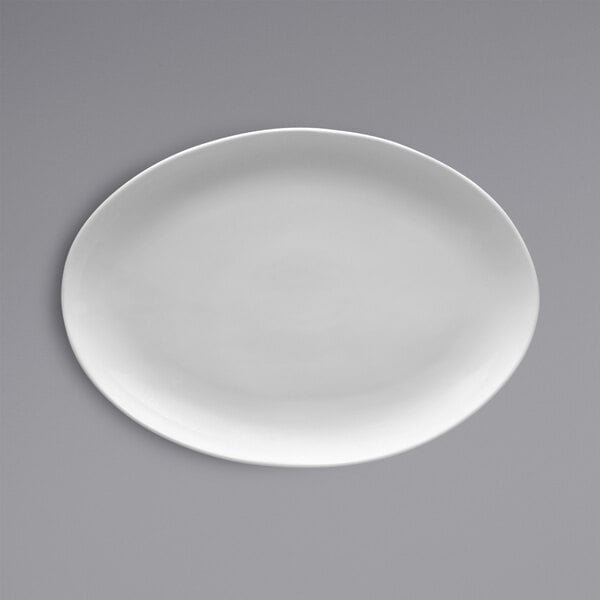 A white oval Fortessa china platter on a gray background.