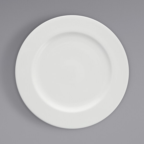 A Fortessa Ilona wide rim china plate with a white rim on a gray surface.