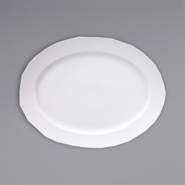 A Fortessa Ilona white china platter with a white rim on a gray surface.