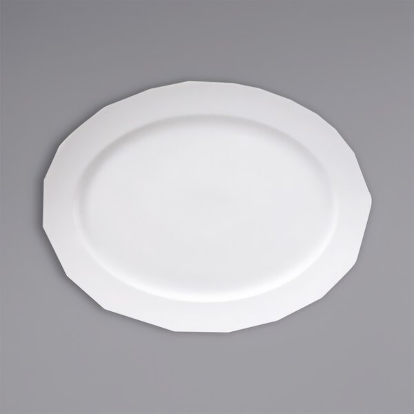 A Fortessa Ilona white china platter with a white rim on a gray surface.