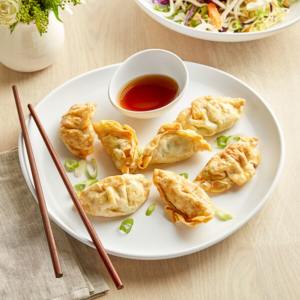 A white GET Enterprises Riverstone melamine plate with fried dumplings and chopsticks.