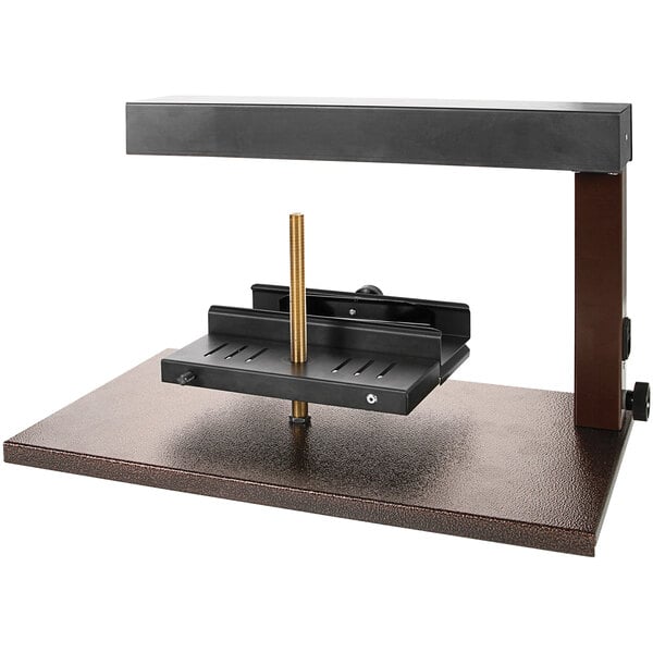 A metal stand with a black and brown metal Boska Raclette Demi.