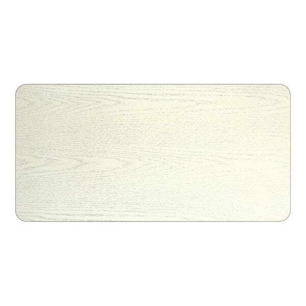 A rectangular reversible laminated table top with a white birch finish.