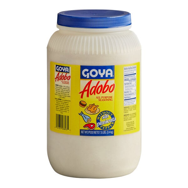 A large plastic container with a blue lid and a yellow label displaying 'Goya Adobo All Purpose Seasoning Without Pepper' in both English and Spanish.