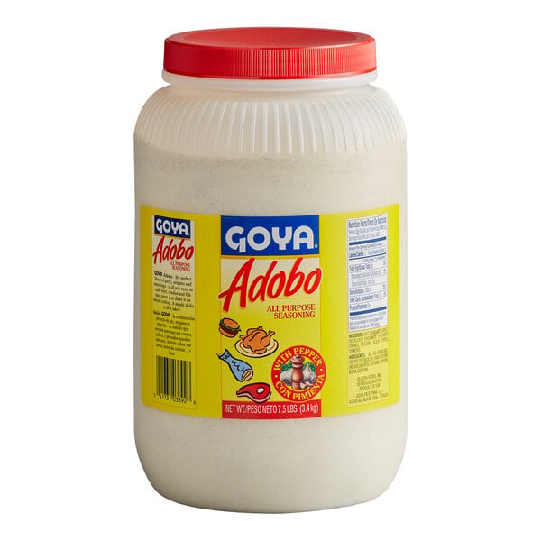 A large plastic container with a red lid, labeled 'Goya Adobo All Purpose Seasoning with Pepper,' featuring a yellow label with images of food and nutritional information.