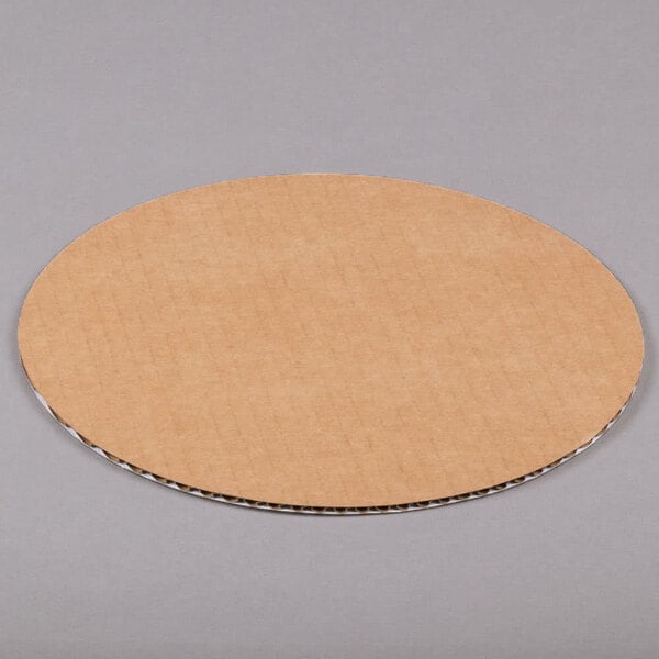 a round brown paper on a gray surface