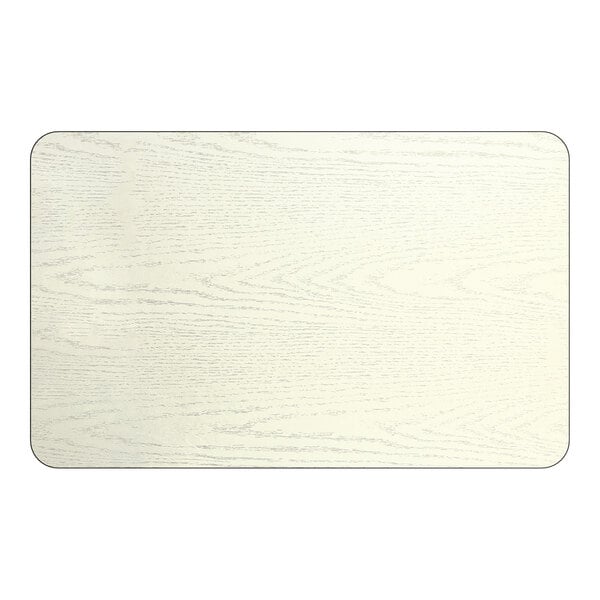 A rectangular reversible laminated table top with a white birch and ash wood grain finish.