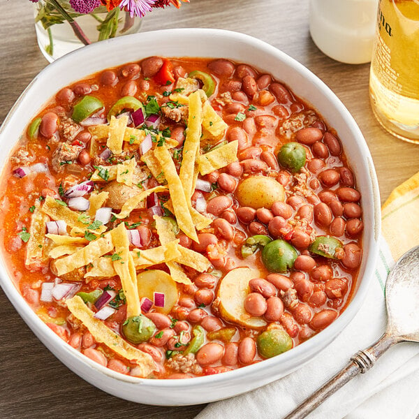 A bowl of Goya pink beans with a spoon.