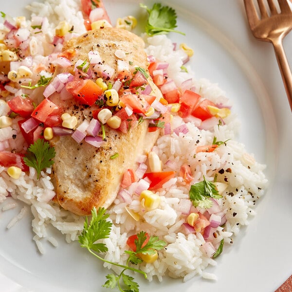 A plate of Goya Canilla rice with chicken and vegetables.