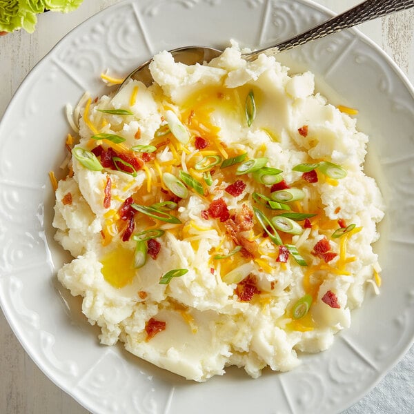 A plate of Idahoan mashed potatoes with a fork.