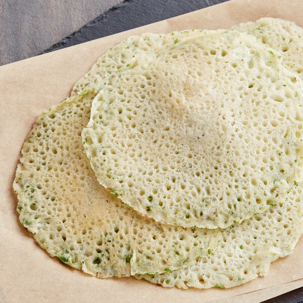 A stack of zucchini rice pancakes on a plate.